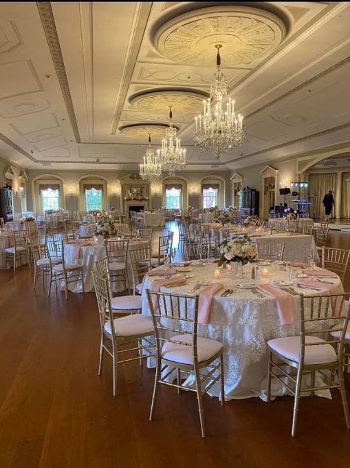 Elegant reception ballroom with floral table arrangements