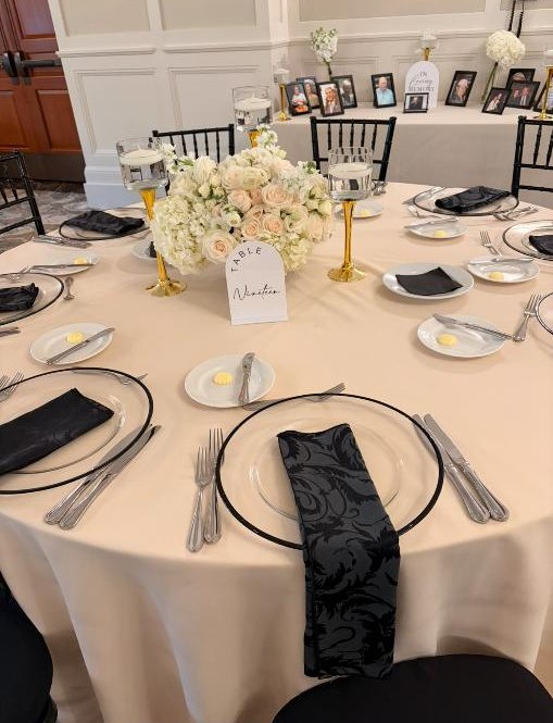 Ivory table linen with white flowers and black accents